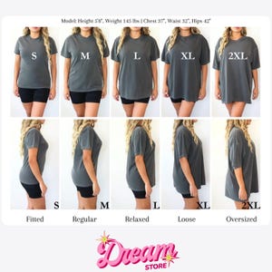 May include: A charcoal gray t-shirt shown in sizes S, M, L, XL, and 2XL, displayed from front and side angles. The image includes text labels for sizes and fits: Fitted, Regular, Relaxed, Loose, and Oversized, plus model measurements: Height 5'8", Weight 145 lbs, Chest 37", Waist 32", Hips 42".