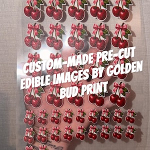 May include: A clear sheet of pre-cut edible cherry images with pink bows, featuring the text CUSTOM-MADE PRE-CUT EDIBLE IMAGES BY GOLDEN BUD PRINT. The sheet contains multiple rows of cherry pairs in varying sizes, arranged on a transparent backing.