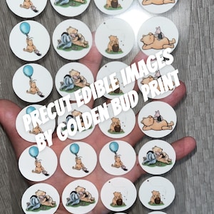 May include: A selection of precut edible images featuring Winnie the Pooh and Piglet. The images are round and white, with various illustrations of the characters. Text on the image reads "PRECUT EDIBLE IMAGES BY GOLDEN BUD PRINT."