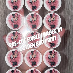 May include: Pre-cut edible images featuring Minnie Mouse in a red dress and bow, surrounded by a pink watercolor effect. The images are round and have the text "PRE-CUT EDIBLE IMAGES BY GOLDEN BUD PRINT".