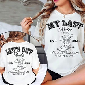 Może przedstawiać: Biała koszulka z czarnym napisem "MY LAST Rodeo" i "LET'S GET Rowdy". Koszulka posiada grafikę z kapeluszem kowbojskim i butem, a także "EST. 2026" i "Meghan's Bachelorette, Nashville, TN".