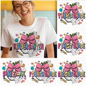 May include: A white t-shirt featuring a graphic of a large apple with a pink bow, surrounded by school supplies like a globe, pencil, book, and paint palette. The text on the shirt reads Kindergarten in colourful, patterned block letters.
