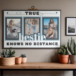 May include: A rectangular wall art print featuring three vertical photo frames with images of friends in shopping carts. The text TRUE bestie KNOWS NO DISTANCE is printed in dark gray and white. A dashed line with location pins spans the top.