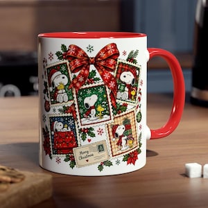 May include: A white ceramic mug with a red handle and interior, featuring a festive design of Snoopy and Woodstock in various holiday scenes framed like postage stamps, accented by a large red bow, holly leaves, and the text Merry Christmas.