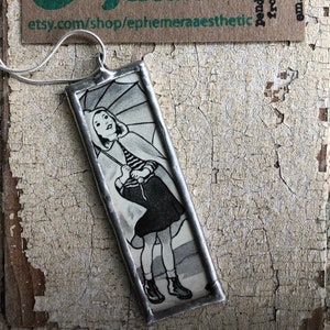Girl with Umbrella and Slicker Necklace (double sided) made from vintage books