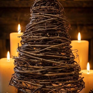 May include: A white ceramic mug with a black handle and the text "But First, Coffee" in a handwritten style. The mug is on a white surface. The mug is likely for hot beverages.