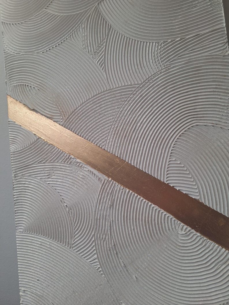 May include: Textured abstract art piece with a gray background and a diagonal copper-colored stripe. The gray surface features a repeating pattern of curved lines, creating a sense of depth and movement. This artwork is suitable for home decor.
