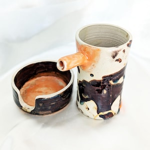 Small stoneware pitcher, detachable lid/cup, cream and orange poured tenmoku glaze — unique handmade piece