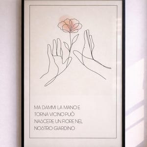 Può includere: Stampa artistica con cornice nera con un disegno a tratto minimalista di mani e un fiore. Il fiore è color pesca e l'opera d'arte include testo italiano in basso.