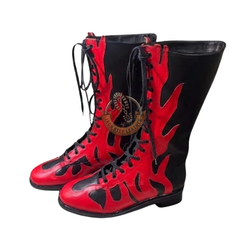 May include: Pair of tall, red and black leather boots with flame-like designs. The boots have a lace-up closure and a high shaft. The brand name "IRON STEP LEATHER" is visible on the side.