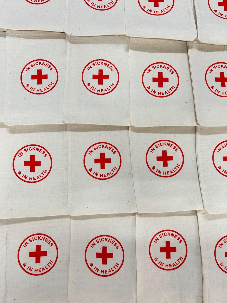 May include: A white ceramic mug with a black handle and the text "But First, Coffee" in a bold, black font. The mug is set against a blurred background, suggesting a cozy setting.