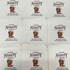 May include: Nine off-white drawstring bags with the text "FOR YOUR NASHTY HANGOVER" above a graphic of a cowboy boot filled with flowers. The text "SMASHED IN NASH 50TH BIRTHDAY BASH!" is below the graphic.