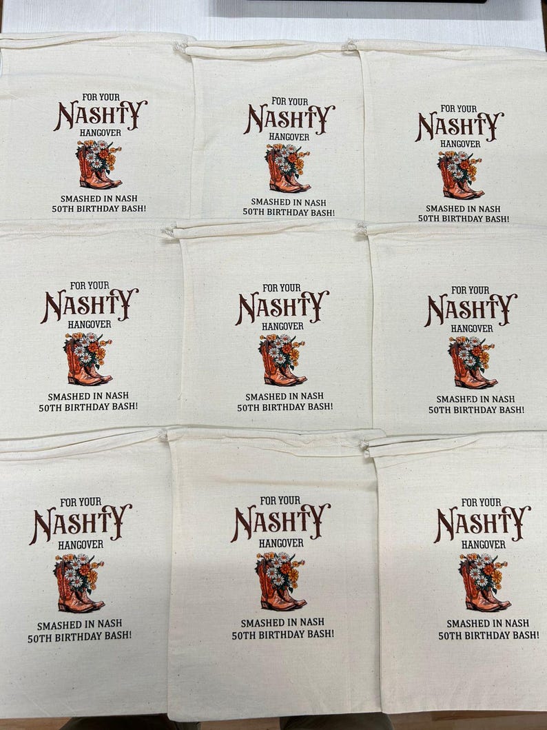 May include: Nine off-white drawstring bags with the text "FOR YOUR NASHTY HANGOVER" above a graphic of a cowboy boot filled with flowers. The text "SMASHED IN NASH 50TH BIRTHDAY BASH!" is below the graphic.