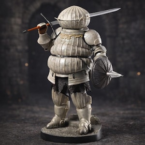 May include: A detailed figurine of a knight in full armor, holding a sword and a spear. The knight's armor is a light gray color with intricate detailing. A small shield with a spike is held in the other hand. The figurine is standing on a stone base.