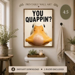 May include: A rectangular wall art print featuring a close-up of a white duck with a prominent orange beak. The text "YOU QUAPPIN'?" is printed in bold black capital letters above the duck. The artwork has a 4:5 aspect ratio.