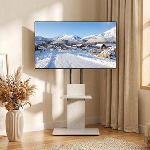 May include: A white wood-grain television stand featuring a central vertical support column, a rectangular base, and a single integrated shelf. The stand holds a flat-screen television displaying a snowy mountain landscape with wooden cabins.