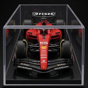 May include: A red Formula 1 race car model displayed inside a clear acrylic case. The car features the number 55, the Ferrari logo, and various sponsor decals including Shell V-Power, HCL Software, AWS, Palantir, Pirelli, Mahle, and Santander.