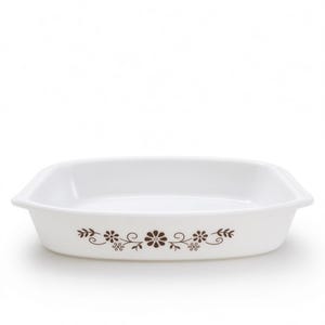 May include: A rectangular white baking dish with rounded corners and integrated side handles. The exterior features a brown floral pattern consisting of stylised flowers, leaves, and swirling vines centred along the front side of the vessel.
