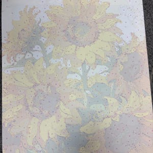 May include: A paint-by-number canvas featuring a floral arrangement of sunflowers. The design is divided into numbered sections with pale yellow, soft green, light blue, and muted beige outlines, providing a guide for applying paint to the surface.