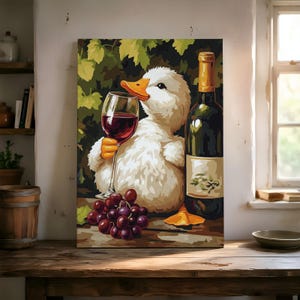 May include: A rectangular canvas print featuring a white duckling holding a stemmed glass of red wine. Beside the duckling stands a dark green wine bottle and a cluster of purple grapes. The background displays green grape leaves and vines.