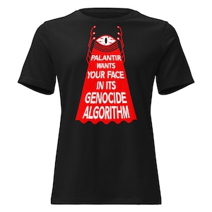 May include: A black short-sleeved t-shirt featuring a graphic of a red eye above a red beam of light. The text reads: PALANTIR WANTS YOUR FACE IN ITS GENOCIDE ALGORITHM. The design is centred on the chest of the shirt with a crew neckline.