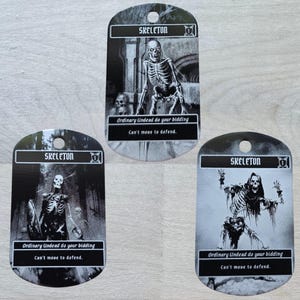 May include: Three black and white skeleton cards with the word "SKELETON" at the top. Each card features a different skeleton illustration and the text "Ordinary Undead do your bidding. Can't move to defend."