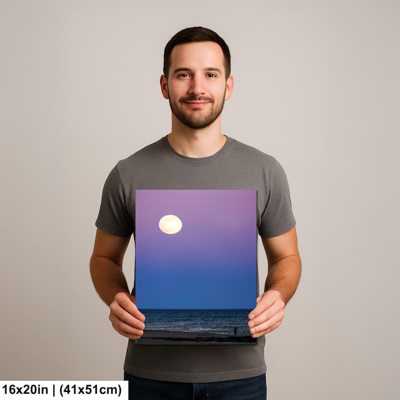 May include: A square canvas print depicting a nighttime seascape. The image features a full moon in a purple and blue sky above the ocean. The print measures 16x20 inches (41x51cm).