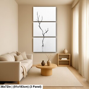 May include: A three-panel wall art piece featuring a minimalist black and white design. The artwork depicts a slender, bare tree branch against a white background. The overall dimensions are 36x72 inches.