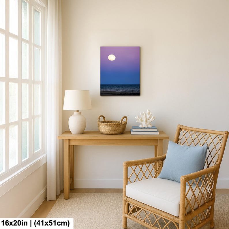 May include: A framed canvas print of a beach scene at dusk. The image features a full moon in a purple and blue sky over the ocean. The canvas measures 16x20 inches (41x51cm).