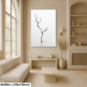 May include: A black and white canvas print featuring a minimalist depiction of a bare tree branch. The artwork is set against a white background, creating a stark contrast. The print measures 40x60 inches.