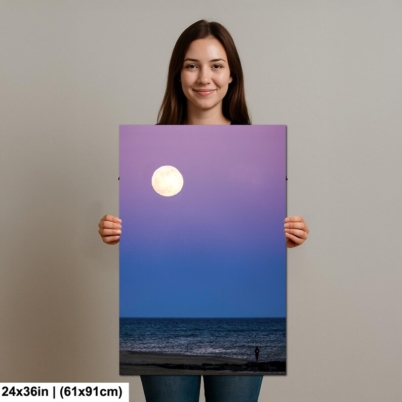 May include: A vertical canvas print featuring a full moon in a purple and blue sky over the ocean. The print measures 24x36 inches.
