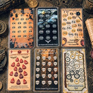 May include: Six rectangular savings challenge cards with various themes and currency values in British pounds. The cards feature printed text including The Wargamer's Savings Crusade, Purge and Save, The Painter's Treasury, Level Up Decree, Battle Fund Challenge, and Imperial Requisition Fund.
