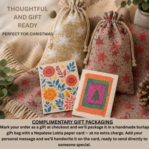 May include: Two drawstring burlap bags featuring star patterns in white and red, accompanied by two rectangular cards. One card displays a colorful floral illustration, while the other features a green Christmas tree on a textured background.