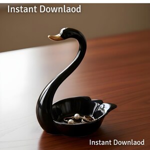 May include: A black ceramic swan-shaped jewelry dish with a gold beak. The dish holds a few rings and a pair of pearl earrings. The words "Instant Download" are at the top and bottom of the image.