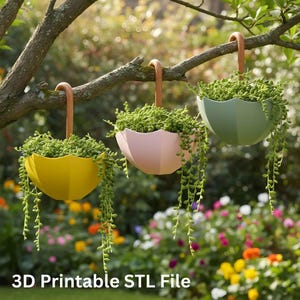May include: Three hanging planters shaped like umbrellas, each filled with trailing green plants. The planters are yellow, pink, and green, suspended from a tree branch by brown handles. The text "3D Printable STL File" is at the bottom.
