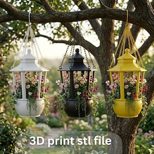May include: Three hanging lantern planters in white, black, and yellow, filled with colourful flowers and greenery. The lanterns are suspended from chains attached to a tree branch. Text at the bottom reads "3D print stl file".