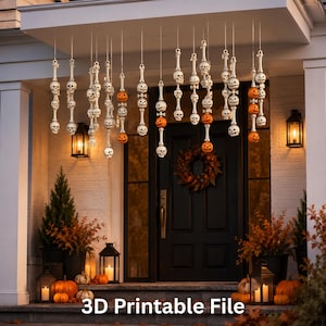 May include: A collection of hanging Halloween decorations featuring white skulls and orange jack-o'-lanterns strung together on vertical lines. The ornaments are suspended from the ceiling of a porch, with the text 3D Printable File at the bottom.