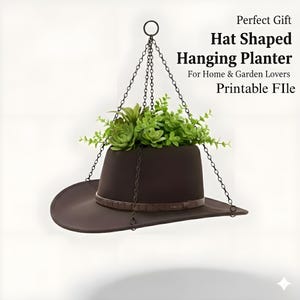 May include: A brown hat-shaped hanging planter filled with green plants, suspended by chains. The planter has a brown leather-like band around the base. Text on the image reads "Perfect Gift Hat Shaped Hanging Planter For Home & Garden Lovers Printable File."