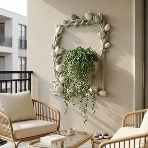 May include: A rectangular wall-mounted planter frame featuring sculpted pale green tulip flowers and leaves along the border. A green semi-circular pot is integrated into the frame, containing a trailing green plant with small round leaves.