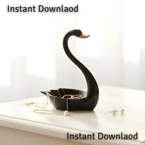 May include: A black swan-shaped jewelry dish with a gold-colored beak. The dish holds gold necklaces, rings, and pearl earrings. The words "Instant Download" are printed at the top and bottom of the image.