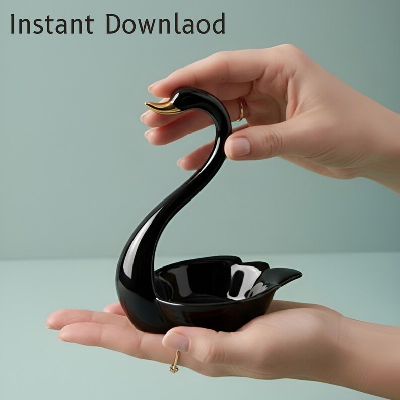 May include: A black ceramic swan-shaped trinket dish with a gold-colored beak. The dish is held in a person's hands. The text "Instant Download" is in the upper left corner.
