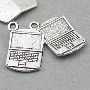 May include: Two silver laptop charms with a detailed design and a silver charm shaped like a laptop lid.