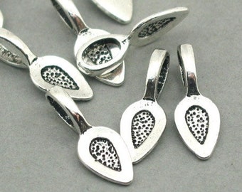 May include: Silver-toned metal pendant bails with a teardrop shape and a textured surface. The bails have a loop at the top for attaching a chain or cord.