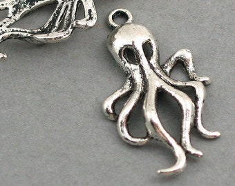 May include: Two silver-toned octopus charms with a detailed design. The charms are perfect for jewelry making or adding a unique touch to crafts.