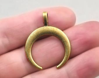 May include: Gold-toned crescent moon pendant charm with a loop at the top for attaching to a necklace or bracelet.