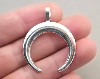 May include: Silver crescent moon pendant charm with a loop at the top for attaching to a necklace or bracelet.