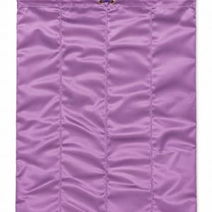 May include: A rectangular purple satin drawstring bag featuring vertical quilted stitching. The top opening is secured with a purple cord threaded through gold-toned metal eyelets, finished with a small gold-toned cylindrical toggle at the end.