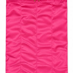 May include: A rectangular hot pink drawstring bag made of a smooth, satin-like fabric. The bag features vertical stitched seams and a matching pink drawstring cord with a small gold-toned metal toggle at the top for secure closure.