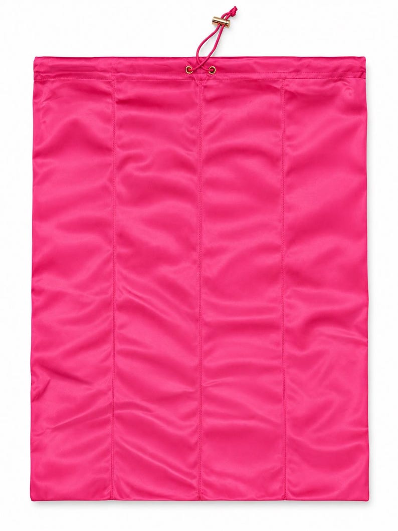 May include: A rectangular hot pink drawstring bag made of a smooth, satin-like fabric. The bag features vertical stitched seams and a matching pink drawstring cord with a small gold-toned metal toggle at the top for secure closure.