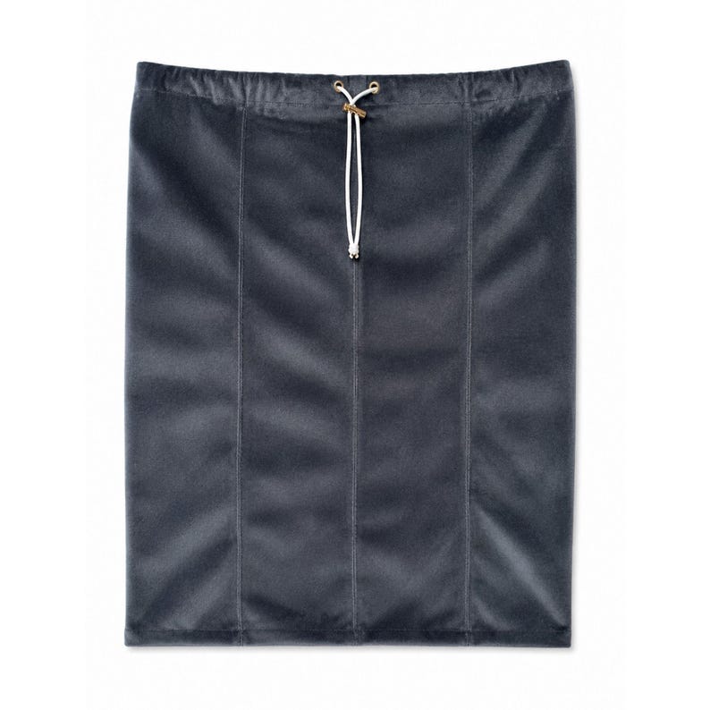 May include: A dark gray velvet skirt featuring a straight silhouette with vertical seam detailing. The garment includes an elasticized waistband with a white drawstring cord threaded through two metal eyelets at the center front.